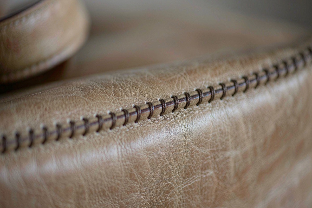 Close view of even lockstitching along a leather bag seam